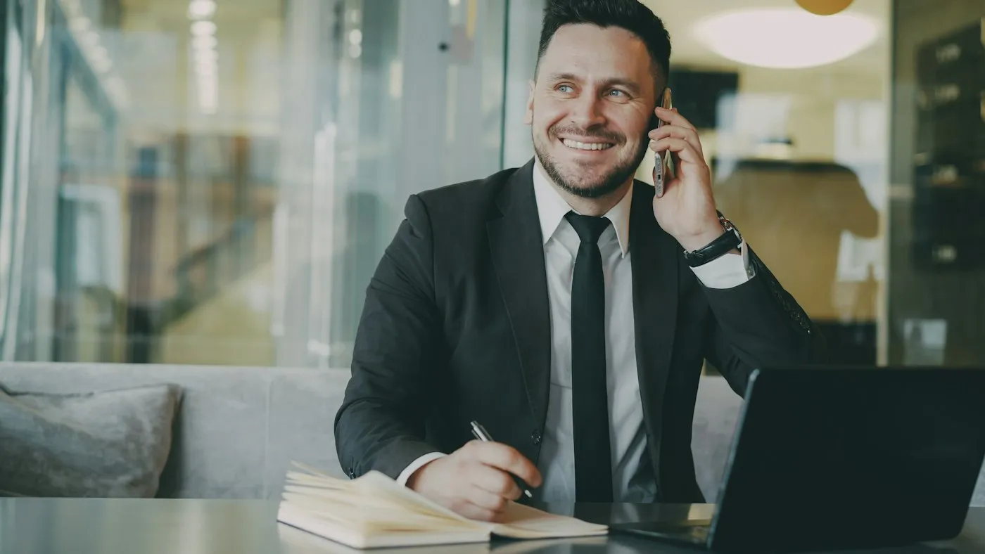 A claims adjuster on the phone at his desk